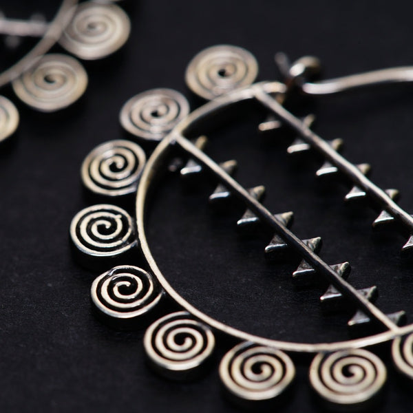 a close up of a pair of earrings on a table