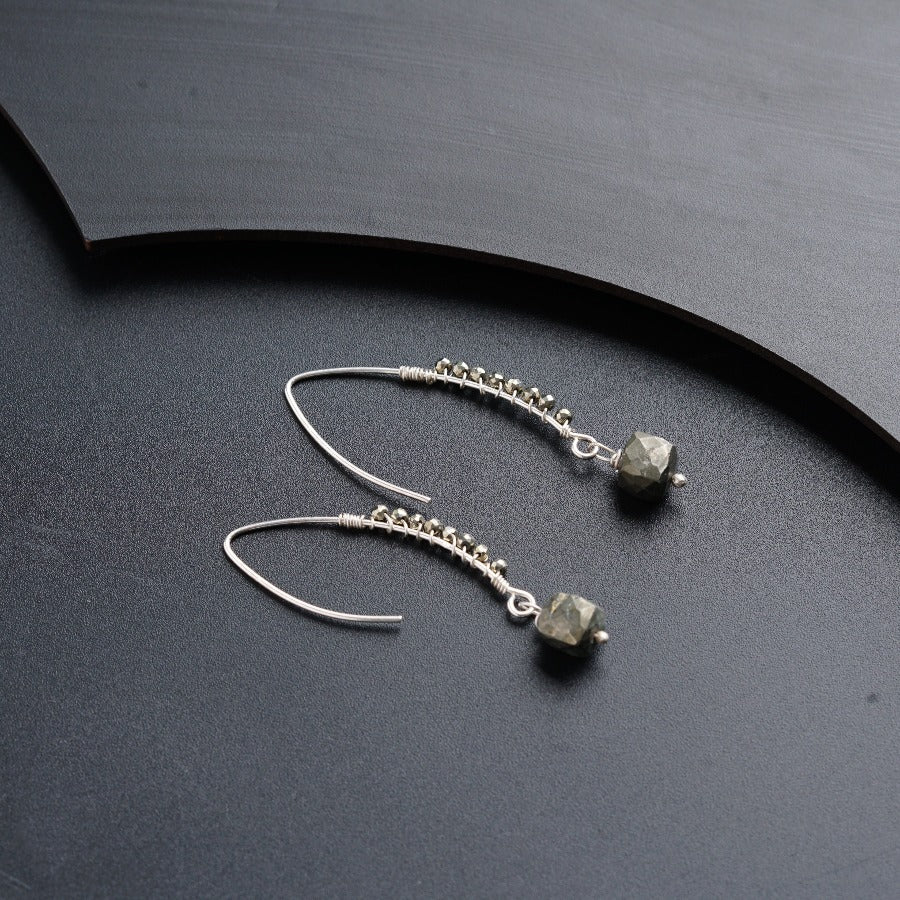 a pair of earrings sitting on top of a table