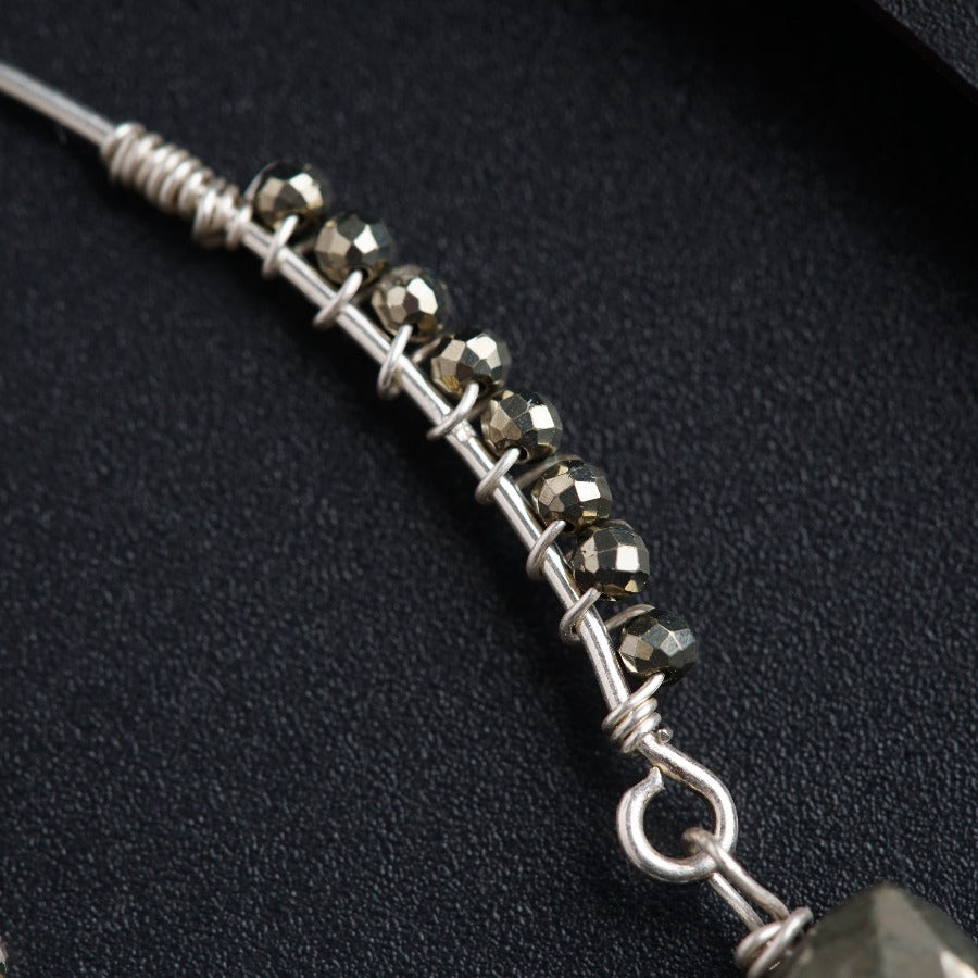 a close up of a necklace on a black surface