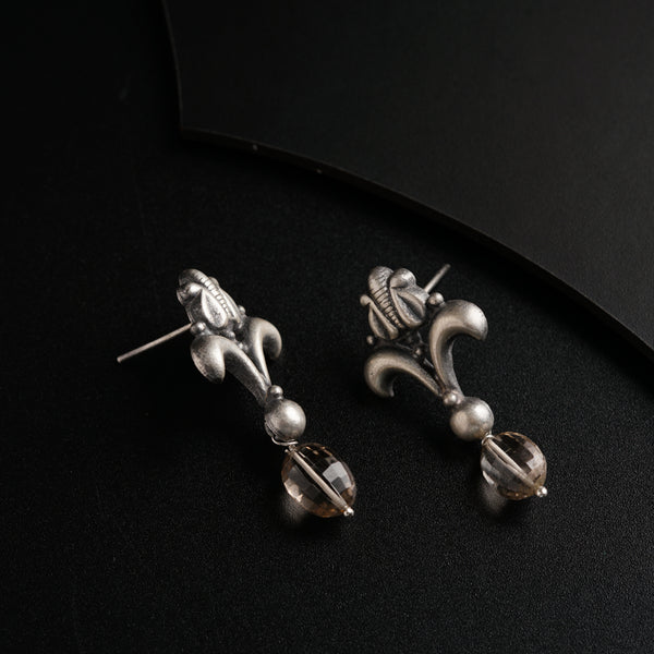 a pair of earrings sitting on top of a table