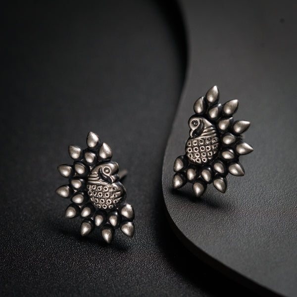 a pair of earrings sitting on top of a table