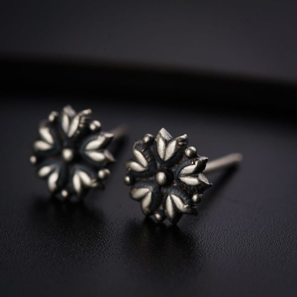 a pair of earrings sitting on top of a table