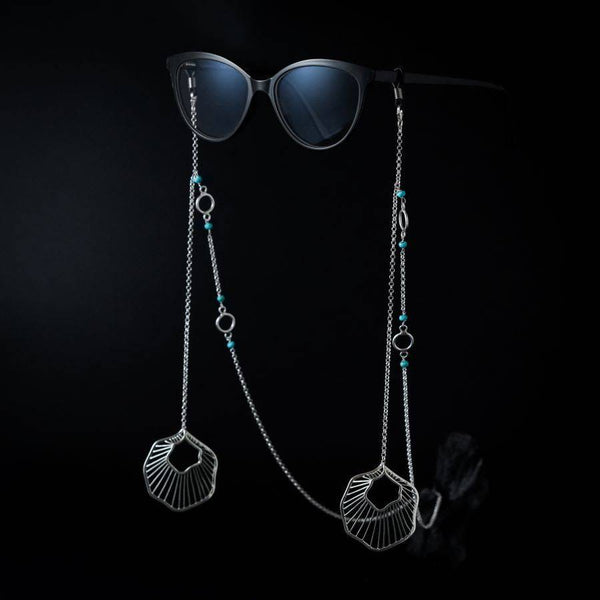 a pair of sunglasses hanging from a chain