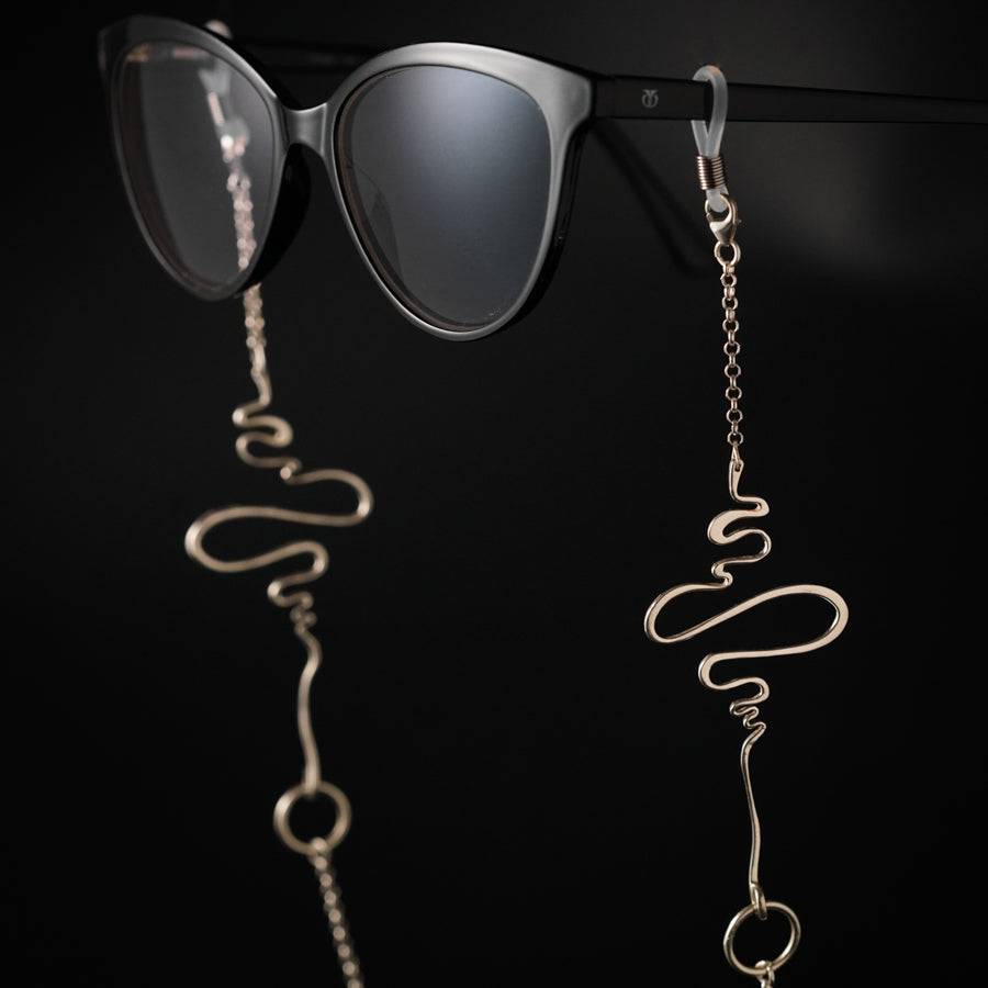 a pair of sunglasses hanging from a metal chain