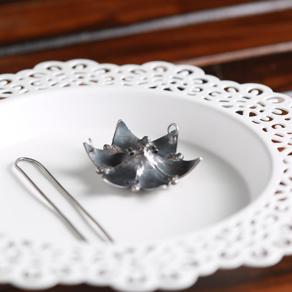 a white plate topped with a metal object