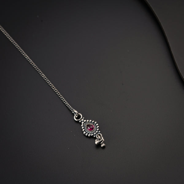 a close up of a necklace on a black surface