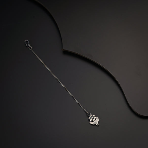 a necklace with a heart on a black background