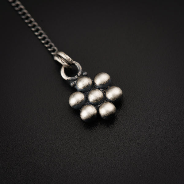 a bunch of silver balls sitting on top of a black surface