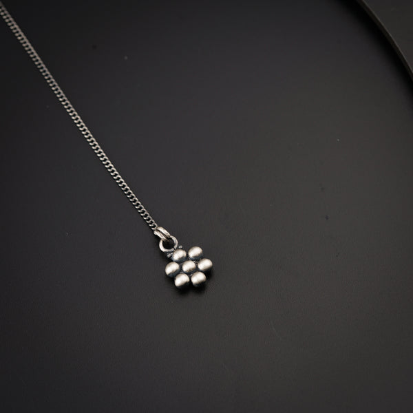 a close up of a necklace on a black surface