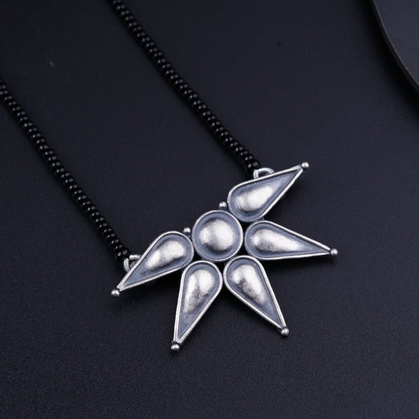 a silver necklace with a star design on it