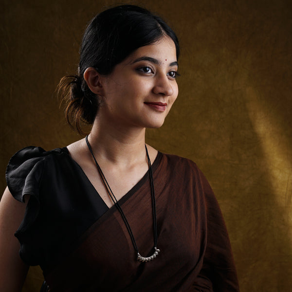 a woman in a brown dress posing for a picture