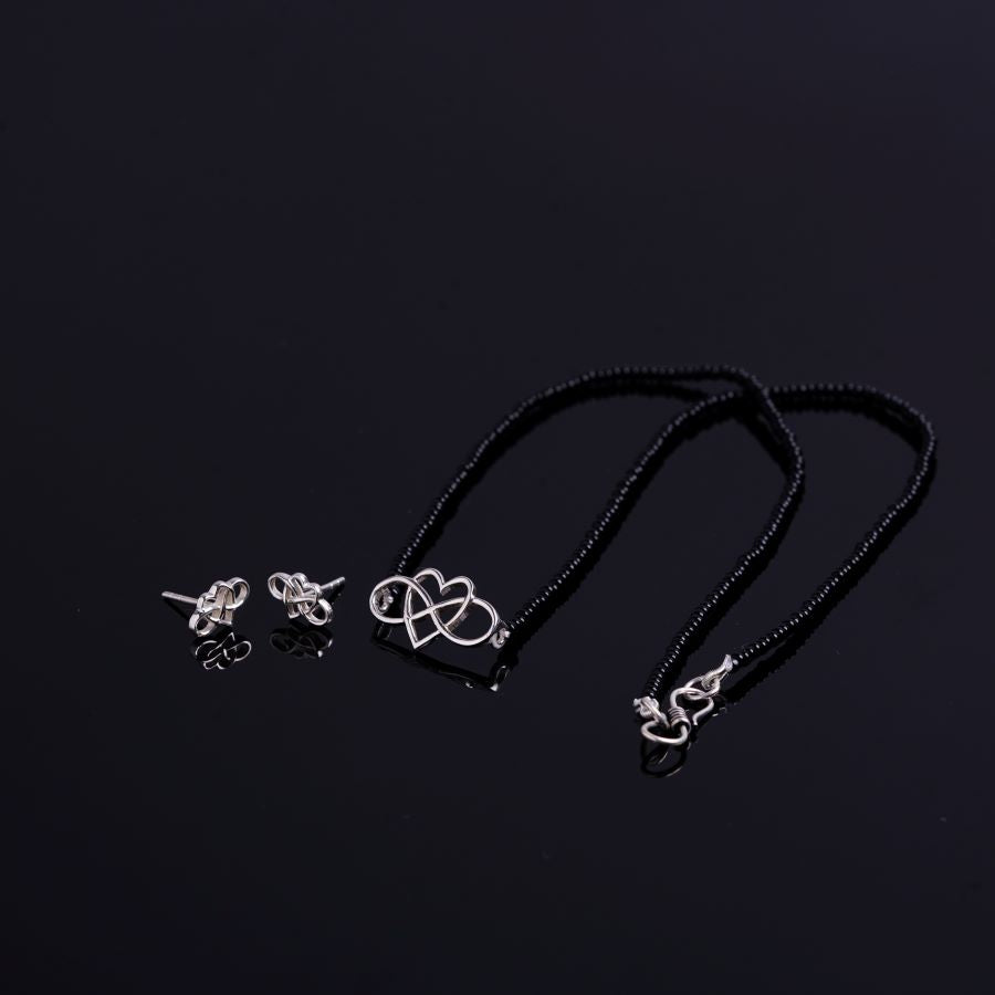 a couple of necklaces sitting on top of a table