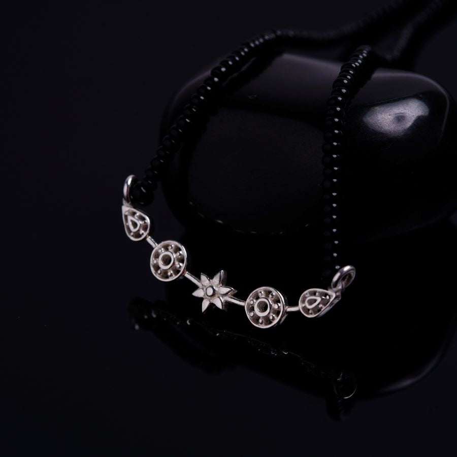 a black beaded bracelet with a star on it