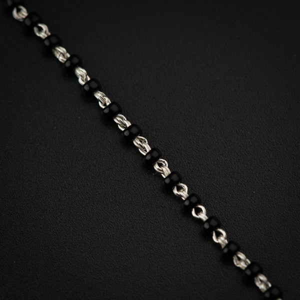 a close up of a chain on a black surface