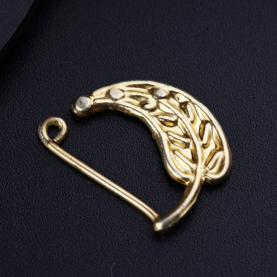 a gold brooch with a leaf design on it