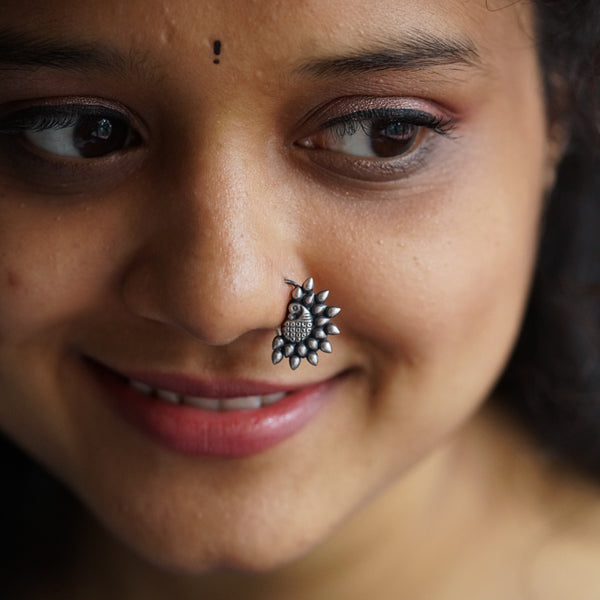 a close up of a woman with a nose piercing