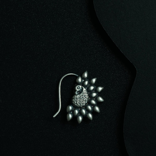 a close up of a brooch on a black background