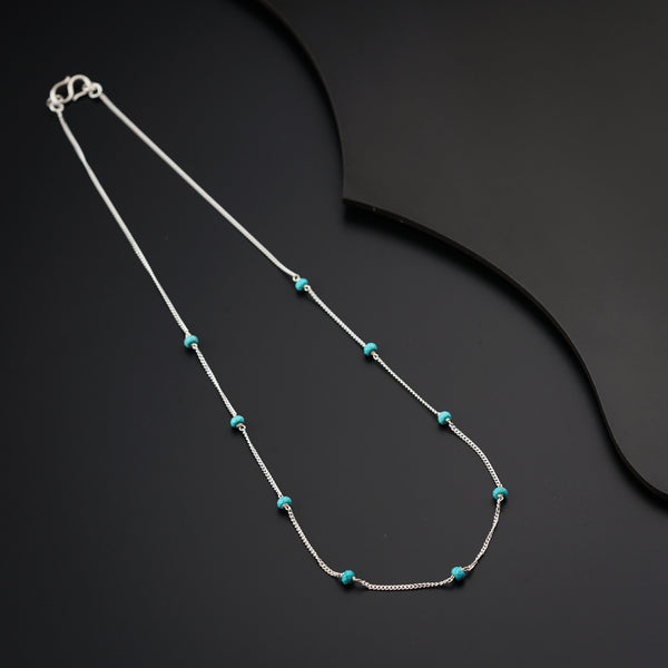 a necklace with turquoise beads and a silver chain