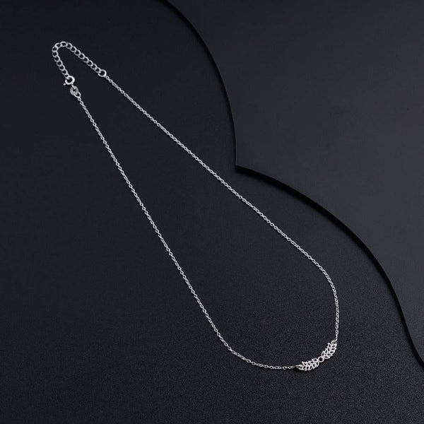 a silver necklace with a chain on a black background