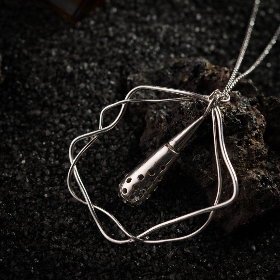 a silver necklace with a hair dryer attached to it