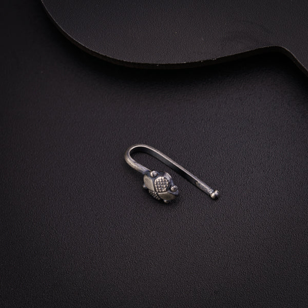 a guitar pick and a pair of scissors on a black surface