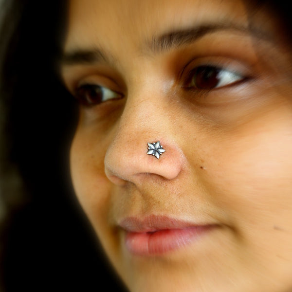 a close up of a woman with a nose piercing