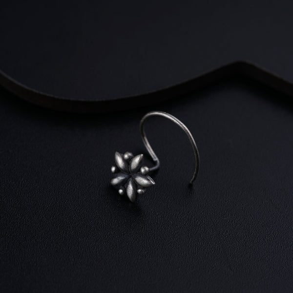 a close up of a pair of earrings on a black surface