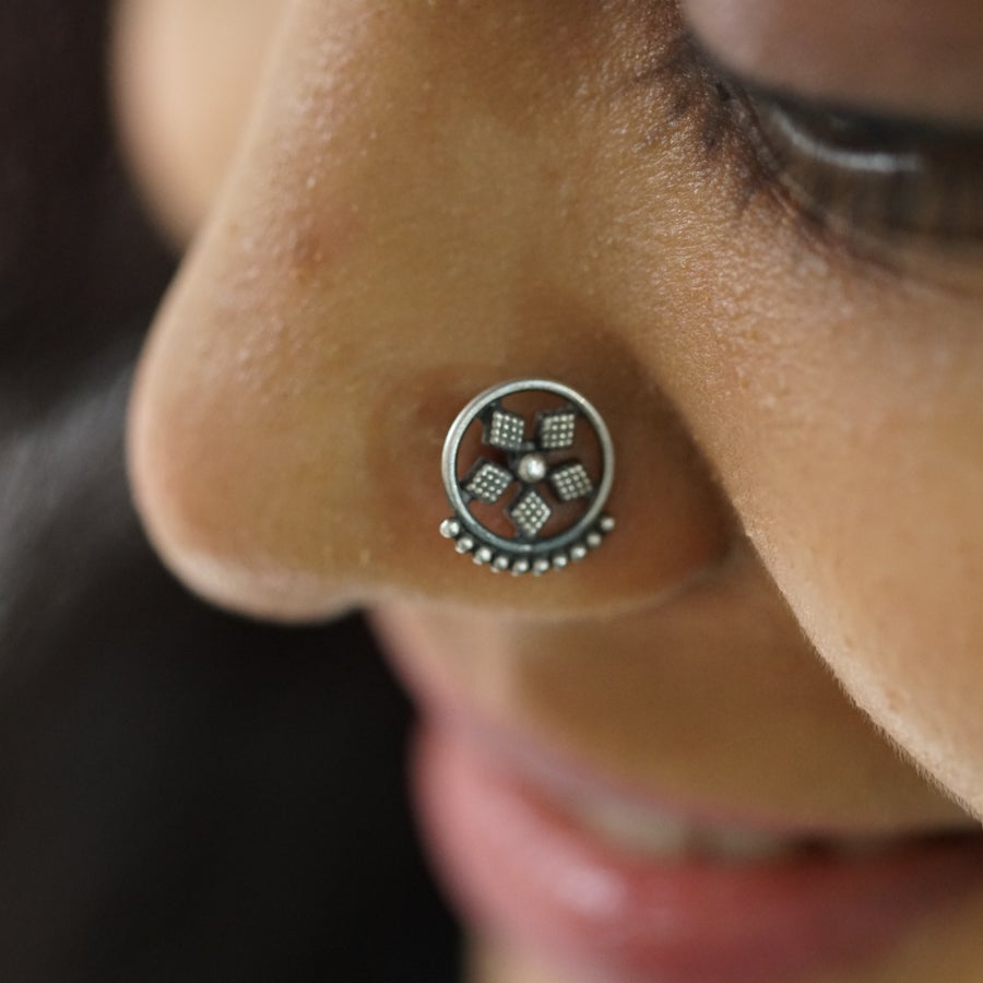 a close up of a person with a nose ring