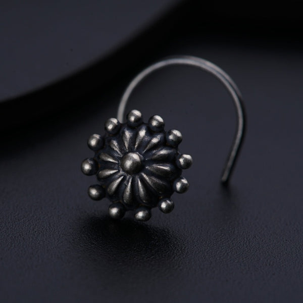 a close up of a metal object on a black surface