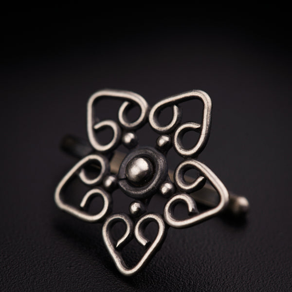 a close up of a metal object on a black surface