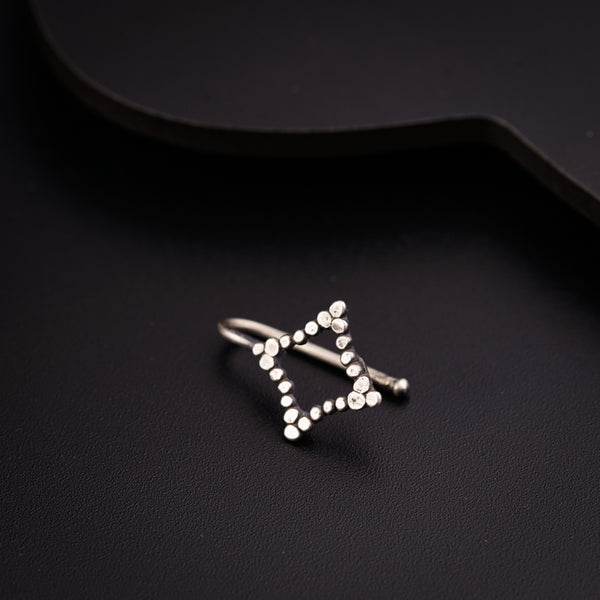 a silver ring sitting on top of a black surface