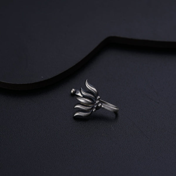 a silver ring sitting on top of a black surface