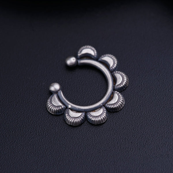 a close up of a metal object on a black surface