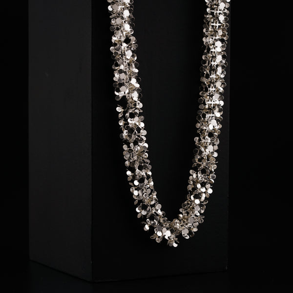 a necklace is displayed on a black box
