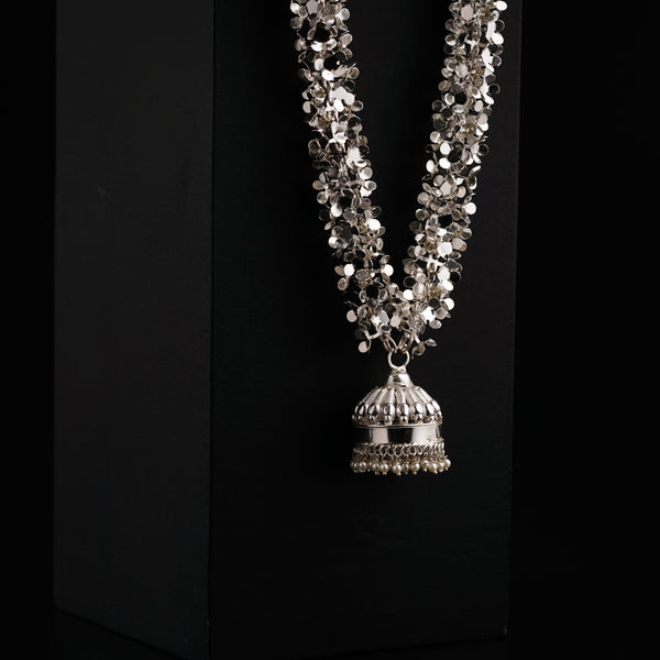 a necklace with a bell hanging from it