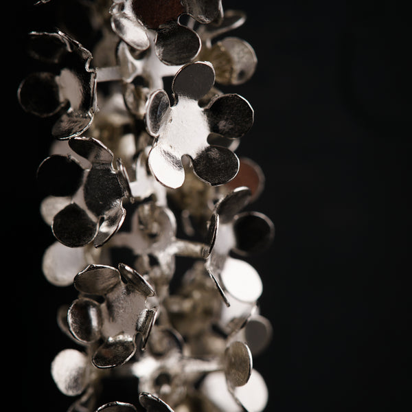 a bunch of metal discs hanging from a ceiling