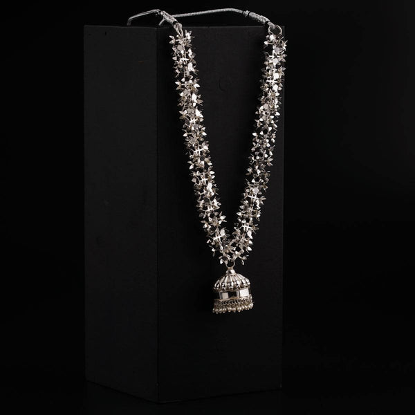 a necklace with a bell hanging from it