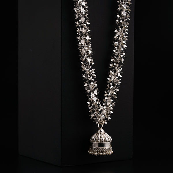 a necklace with a bell hanging from it