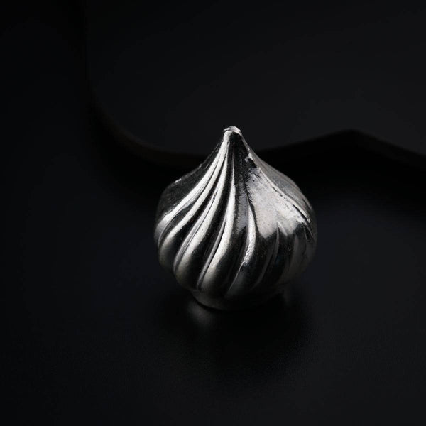 a silver ring sitting on top of a black surface