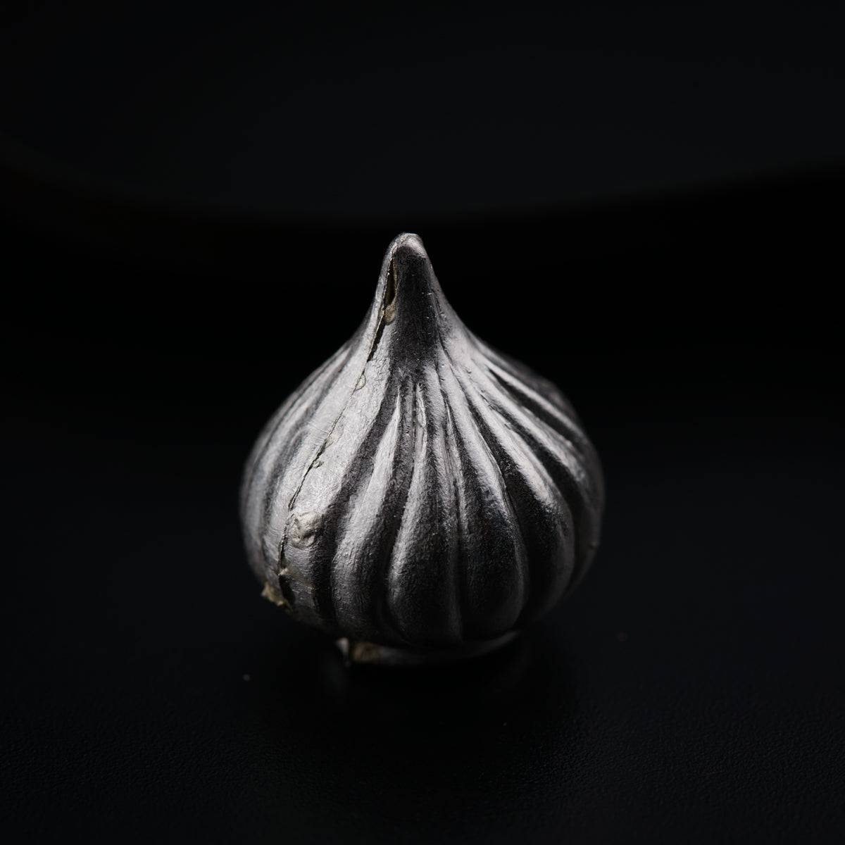a close up of a garlic on a black background