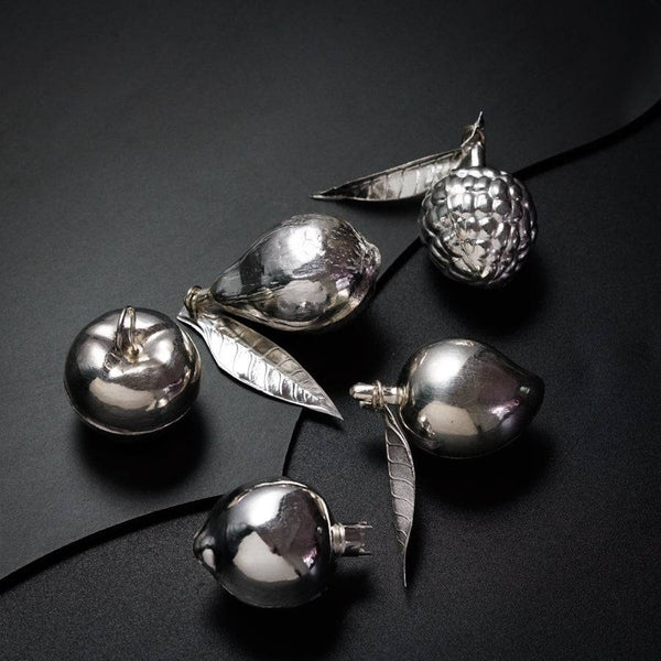 a group of silver ornaments sitting on top of a table