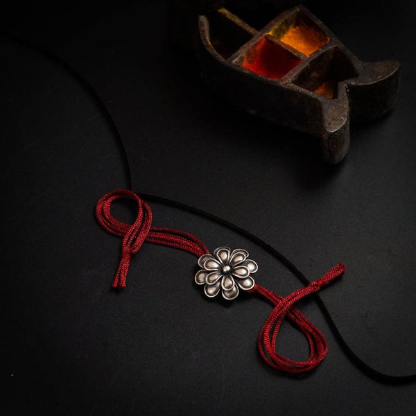 a red string with a flower on it
