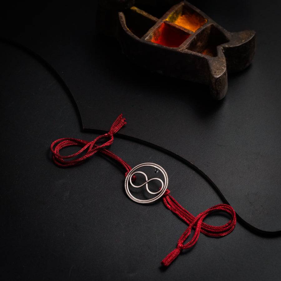 a red cord with a silver circle on it