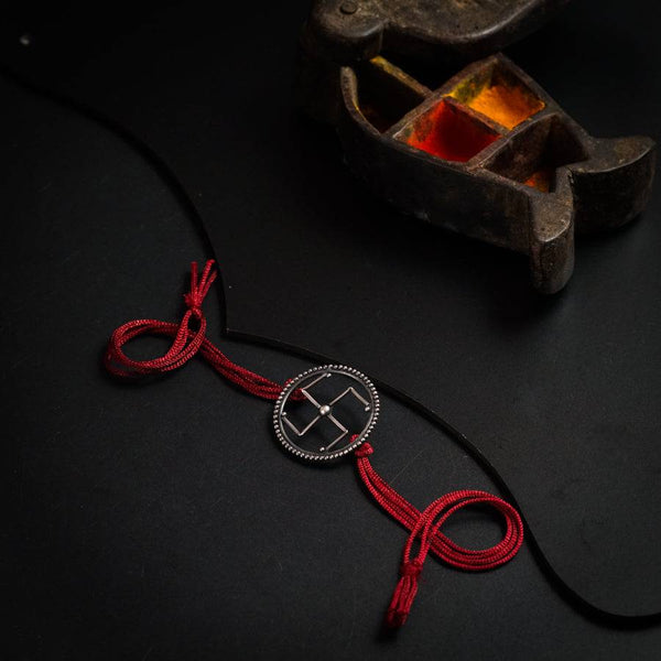 a pair of shoes with a red cord attached to it