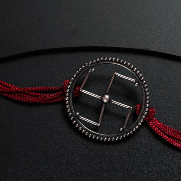 a black and red belt with a metal buckle