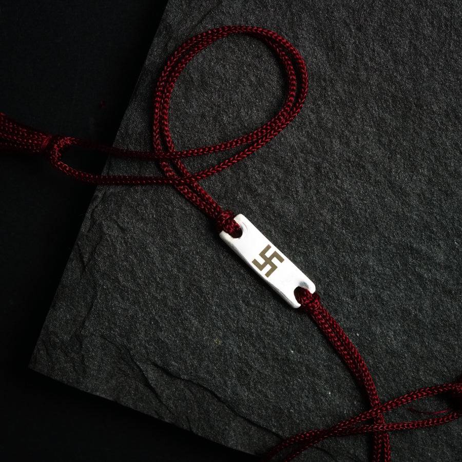 a red rope with a white tag attached to it