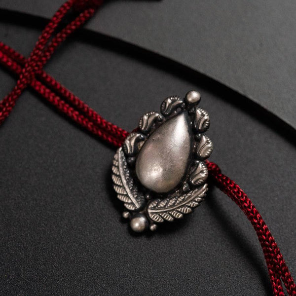 a close up of a necklace on a black surface