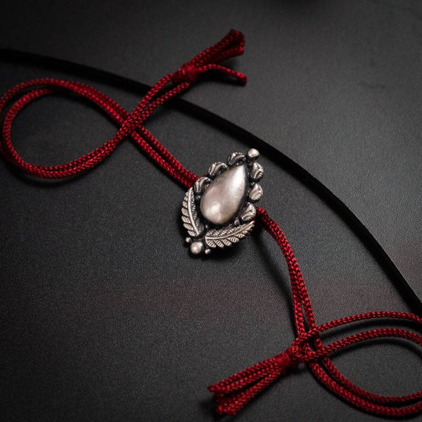 a close up of a necklace on a black surface