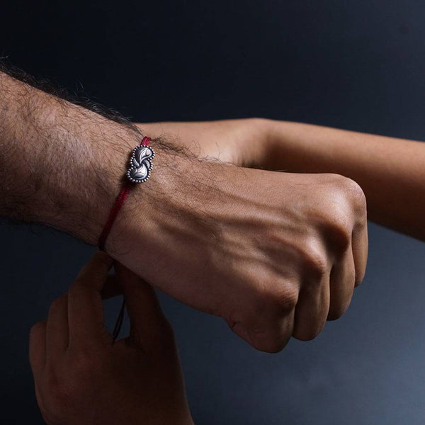 a man's arm with a bracelet on it