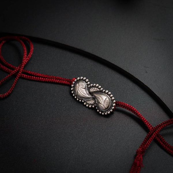 a red cord with a silver clasp on it